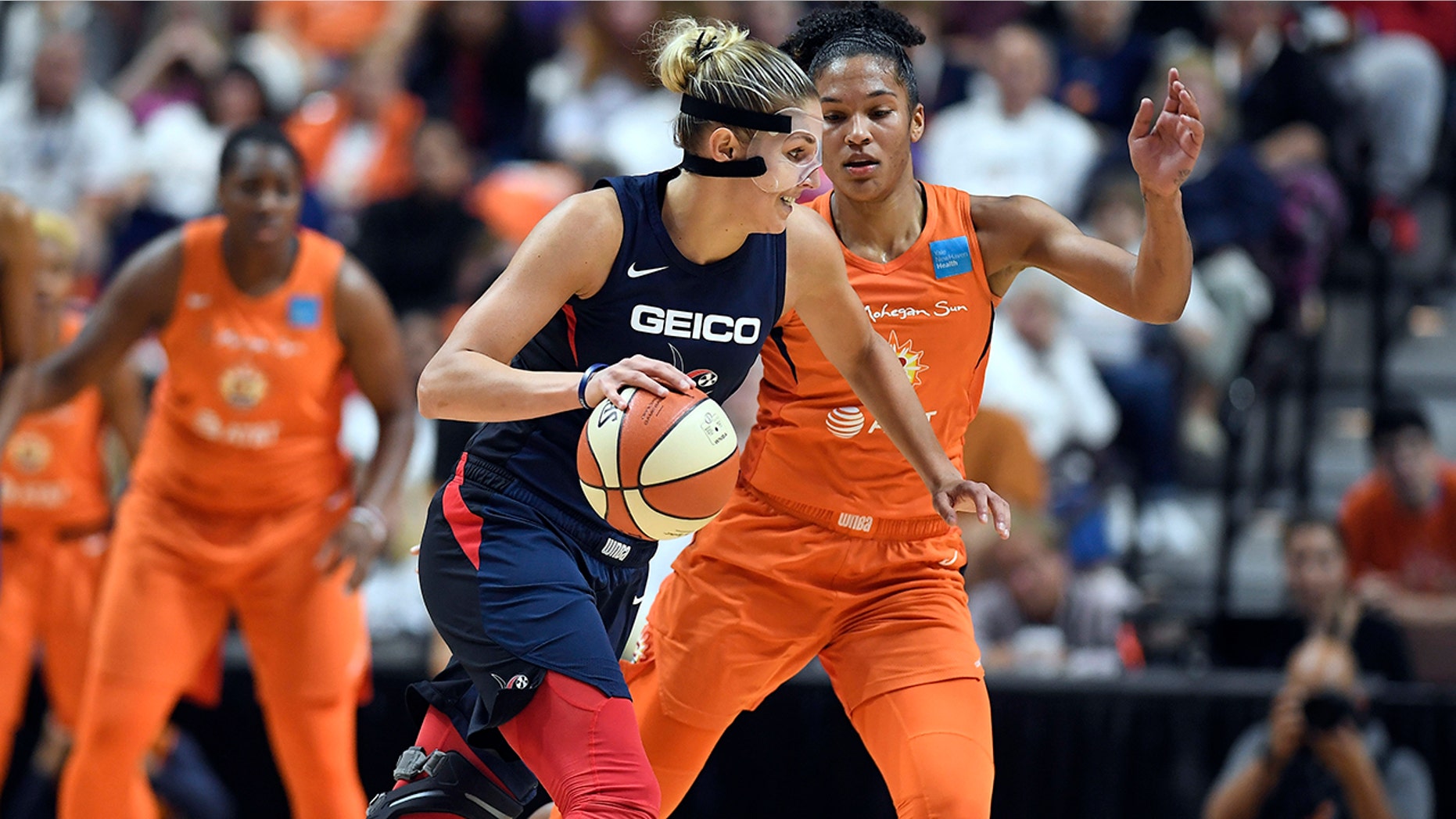 Washington Mystics' Elena Delle Donne, front, drives against Connecticut Sun's Alyssa Thomas during the first half in Game 3 of basketball's WNBA Finals, Sunday, Oct. 6, 2019, in Uncasville, Conn. (AP Photo/Jessica Hill)