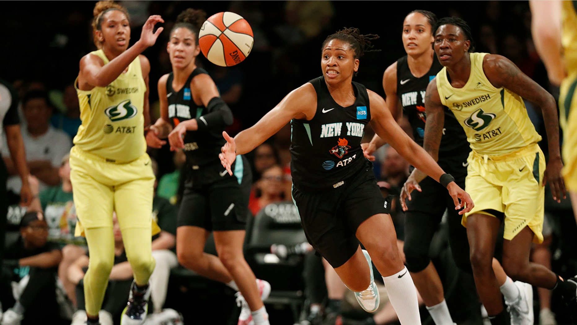 FILE - In this Aug. 11, 2019, file photo, New York Liberty guard Tanisha Wright, center, goes after a loose ball during the first half of the team's WNBA basketball game against the Seattle Storm at Barclays Center in New York. The Liberty will have a new home next year, playing their games at Barclays Center. (AP Photo/Kathy Willens, File)