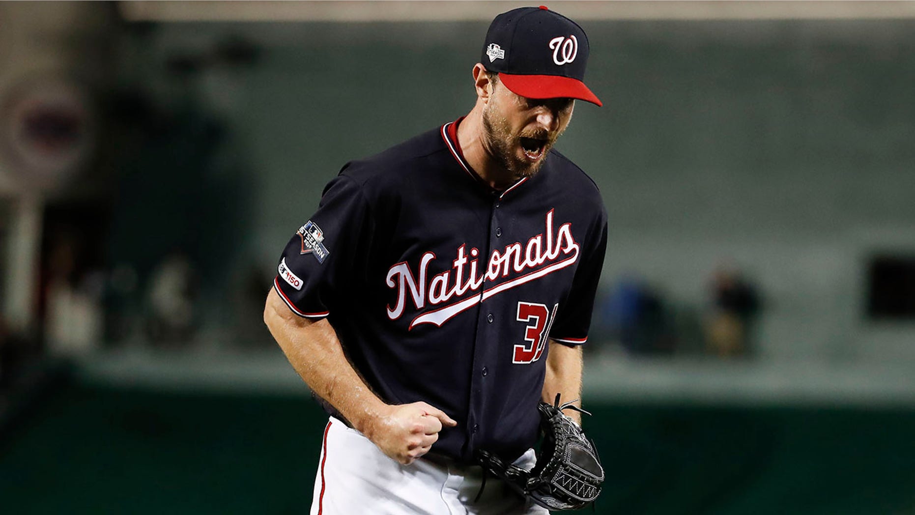 Washington Nationals starting pitcher Max Scherzer (31) reacts after striking out Los Angeles Dodgers left fielder Chris Taylor (3) in the seventh inning in Game 4 of a baseball National League Division Series, Monday, Oct. 7, 2019, in Washington. (AP Photo/Alex Brandon)