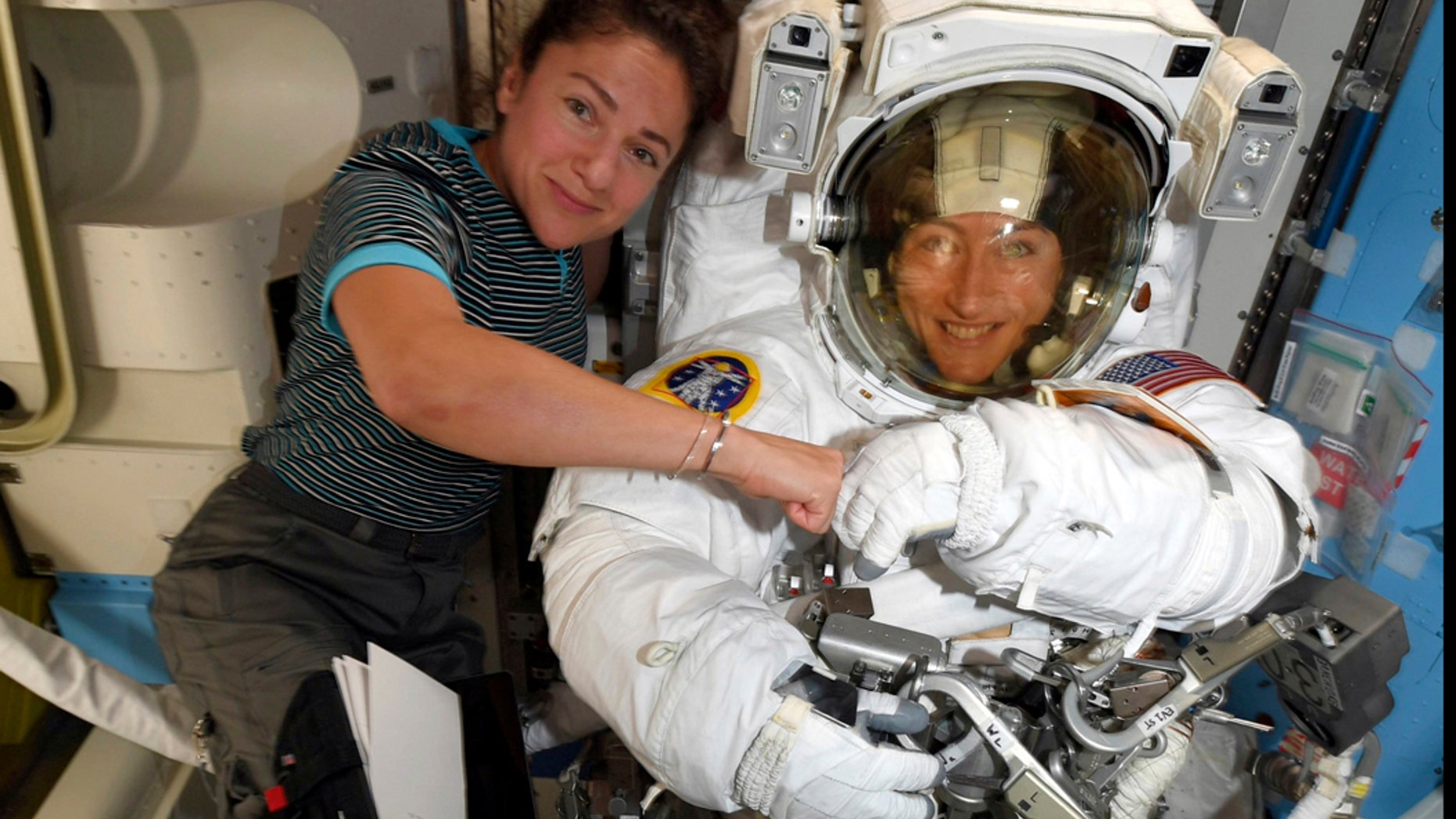 FILE - In this image released Friday, Oct. 4, 2019, by NASA, astronauts Christina Koch, right, and, Jessica Meir pose for a photo on the International Space Station. NASA has moved up the first all-female spacewalk to Thursday, Oct. 17, 2019, or Friday because of a power system failure at the International Space Station. (NASA via AP)