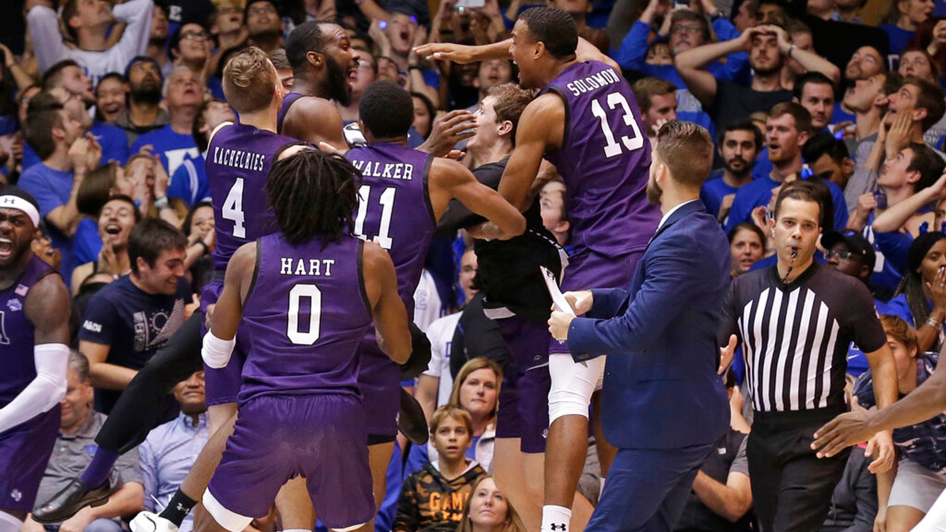 Stephen F. Austin players celebrate the team's 85-83 overtime win over Duke in an NCAA college basketball game in Durham, N.C.