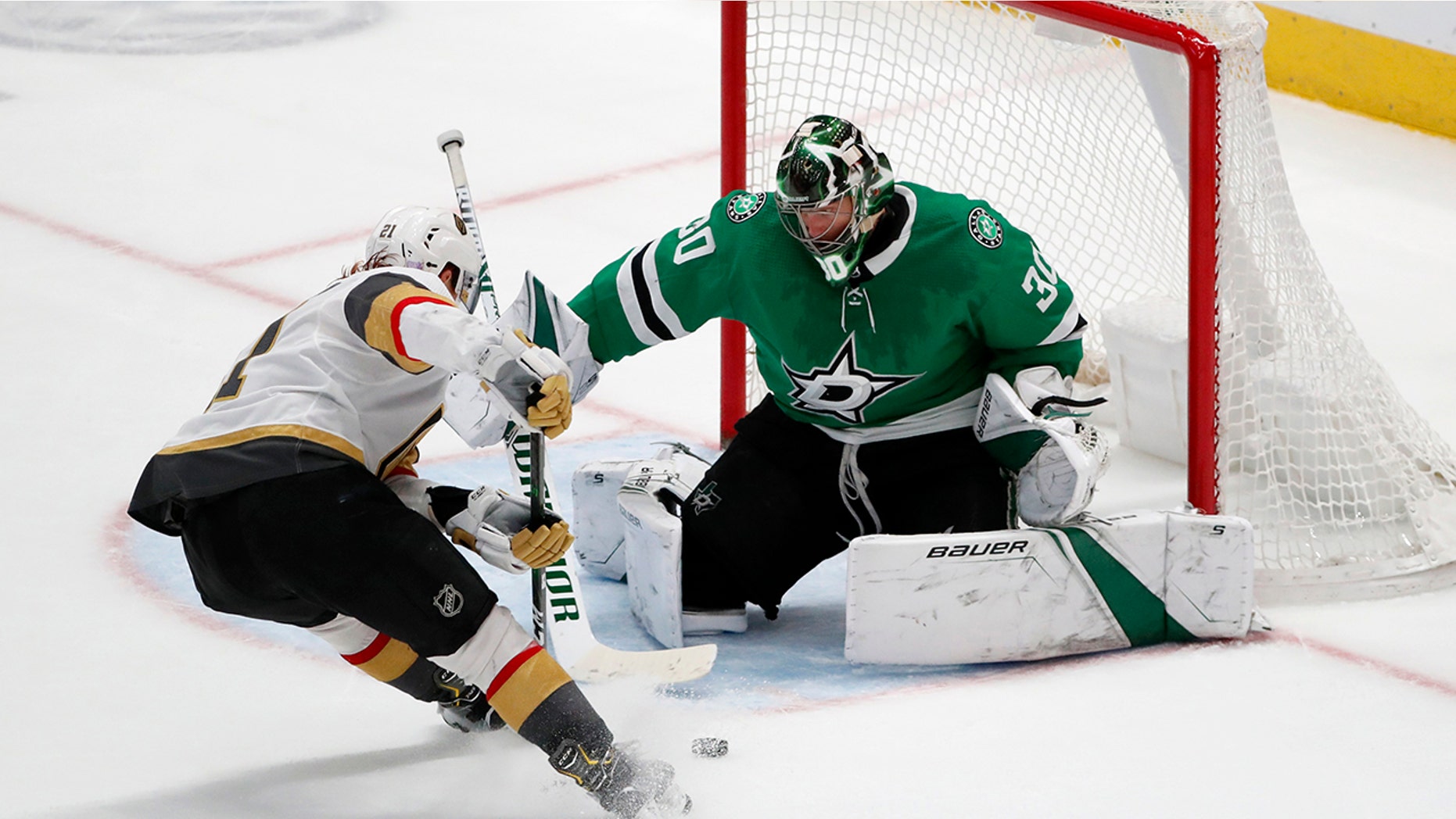 Dallas Stars goaltender Ben Bishop (30) makes a save against a shot from Vegas Golden Knights center Cody Eakin (21) in the third period of an NHL hockey game in Dallas, Monday, Nov. 25, 2019. (AP Photo/Tony Gutierrez)