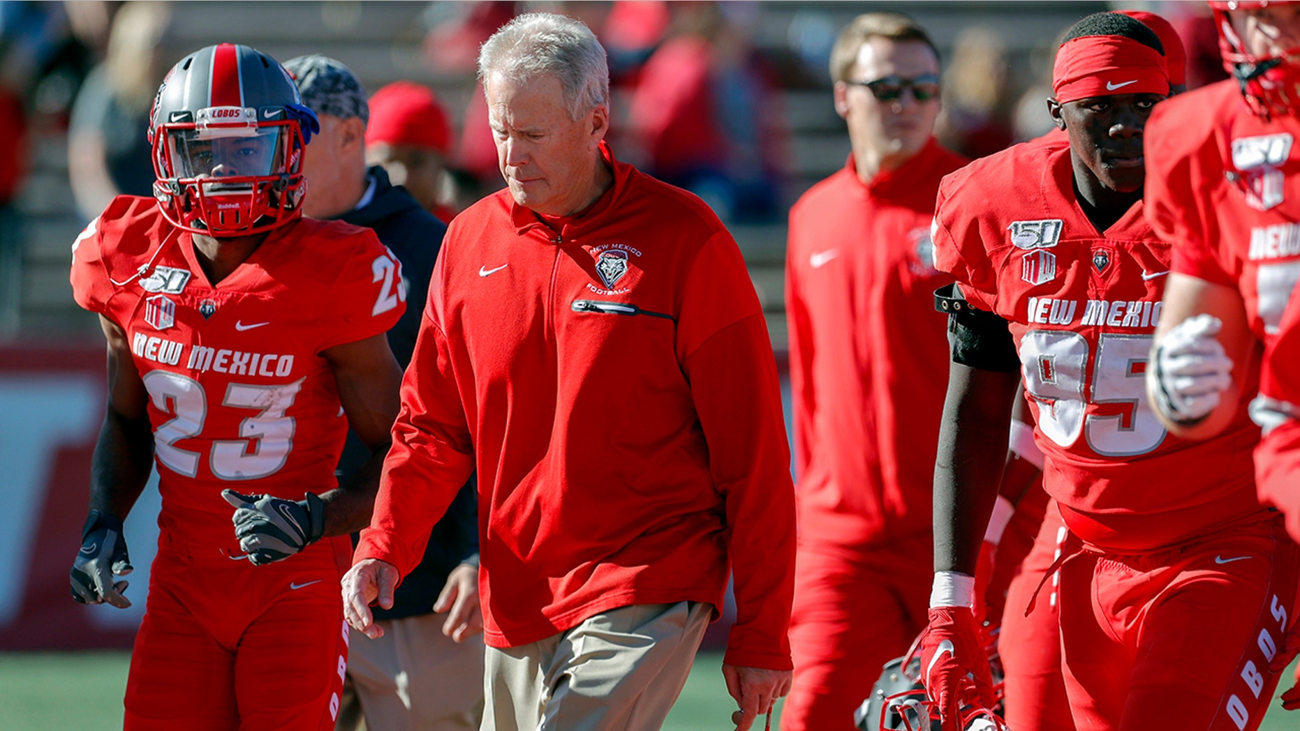 FILE - In this Saturday, Oct. 26, 2019, file photo, New Mexico coach Bob Davie leads his team from the field at halftime of an NCAA college football game against Hawaii in Albuquerque, N.M. On Monday, Nov. 25, Davie agreed to step aside as New Mexico’s coach at the end of the season, ending an uneven eight-season tenure with the Lobos. (AP Photo/Andres Leighton, File)