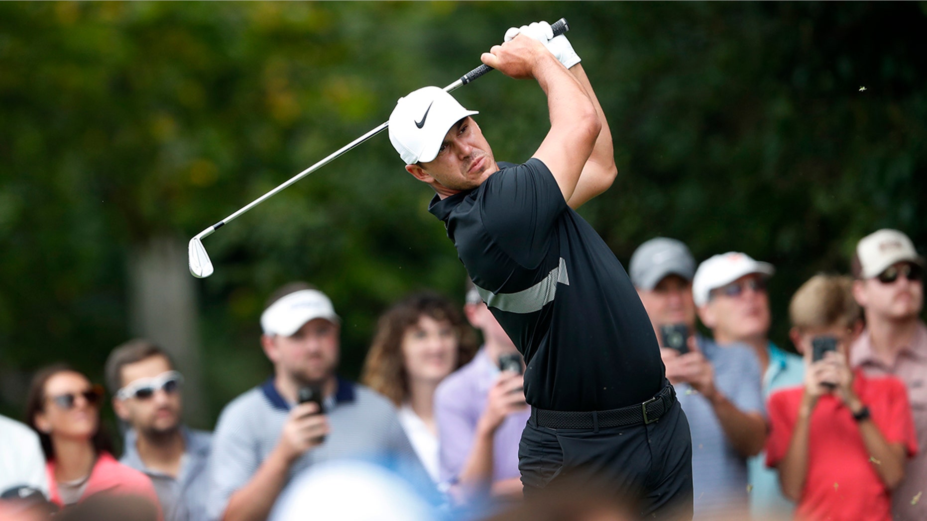 FILE - In this Aug. 25, 2019, file photo, Brooks Koepka hits from the second tee during the final round of the Tour Championship golf tournament at East Lake Golf Club in Atlanta. Koepka has withdrawn from the Presidents Cup because of a knee injury he suffered last month in South Korea. Koepka is the No. 1 player in the world and was the leading qualifier for the Presidents Cup, which will be played Dec. 12-15 at Royal Melbourne in Australia. Koepka will be replaced by Rickie Fowler. (AP Photo/John Bazemore, File)