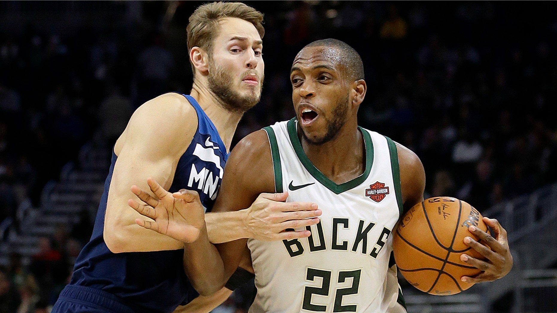 FILE - In this Oct. 17, 2019, file photo, Milwaukee Bucks' Khris Middleton (22) drives to the basket against Minnesota Timberwolves' Jake Layman during the first half of a preseason NBA basketball game in Milwaukee. Middleton is expected to be sidelined for up to a month after suffering a left thigh contusion. (AP Photo/Aaron Gash, File)