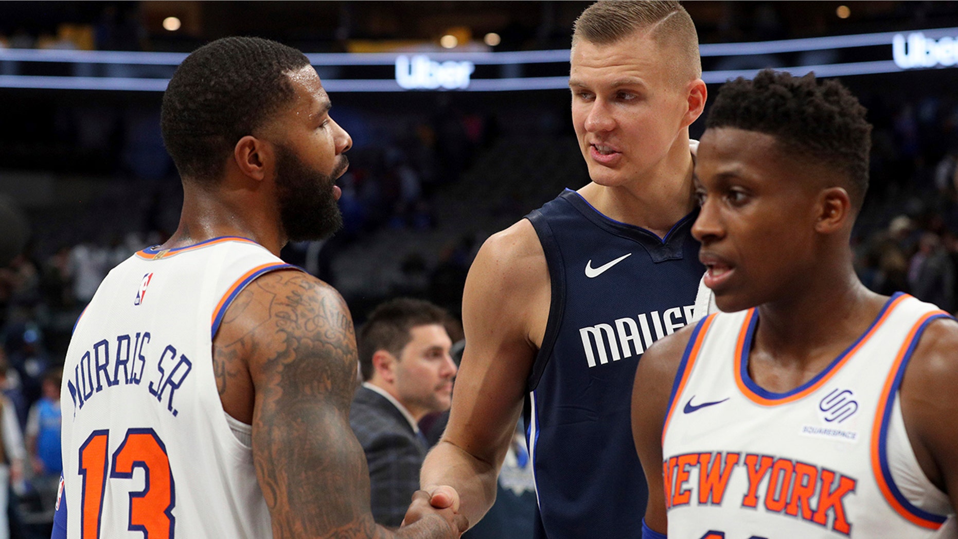 New York Knicks forward Marcus Morris (13) shakes hands with Dallas Mavericks forward Kristaps Porzingis (6) after NBA basketball game Friday, Nov. 8, 2019, in Dallas. (AP Photo/Richard W. Rodriguez)