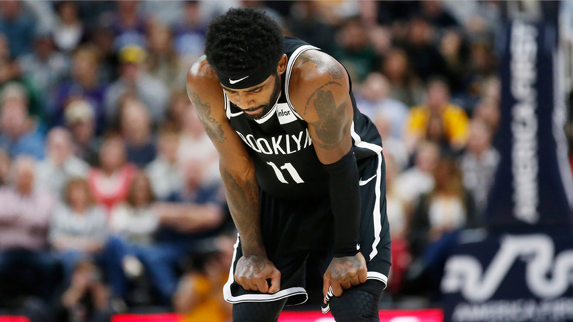 Brooklyn Nets guard Kyrie Irving (11) looks down at the court during the second half of the team's NBA basketball game against the Utah Jazz on Tuesday, Nov. 12, 2019, in Salt Lake City. (AP Photo/Rick Bowmer)