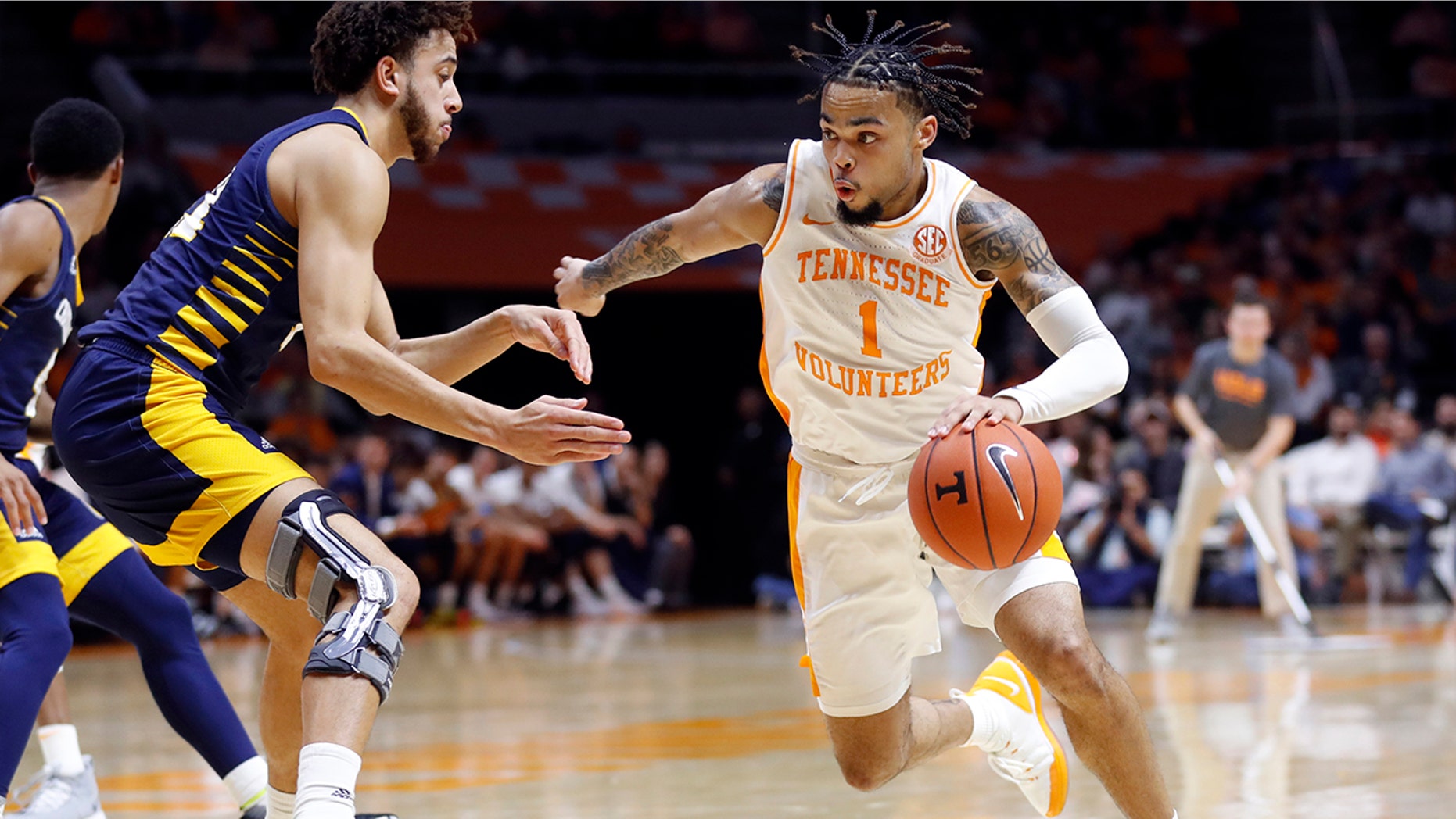 Tennessee guard Lamonte Turner, right, drives against Chattanooga forward Rod Johnson, left, during the second half of an NCAA college basketball game Monday, Nov. 25, 2019, in Knoxville, Tenn. (AP Photo/Wade Payne)