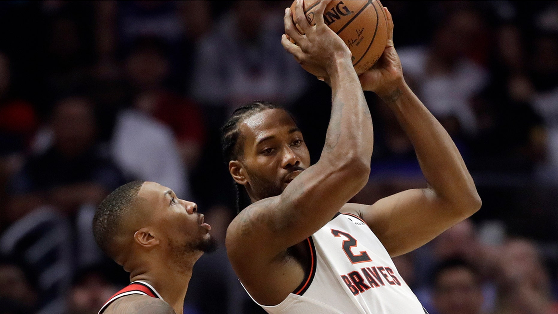 Los Angeles Clippers' Kawhi Leonard (2) is defended by Portland Trail Blazers' Damian Lillard during the first half of an NBA basketball game Thursday, Nov. 7, 2019, in Los Angeles. (AP Photo/Marcio Jose Sanchez)