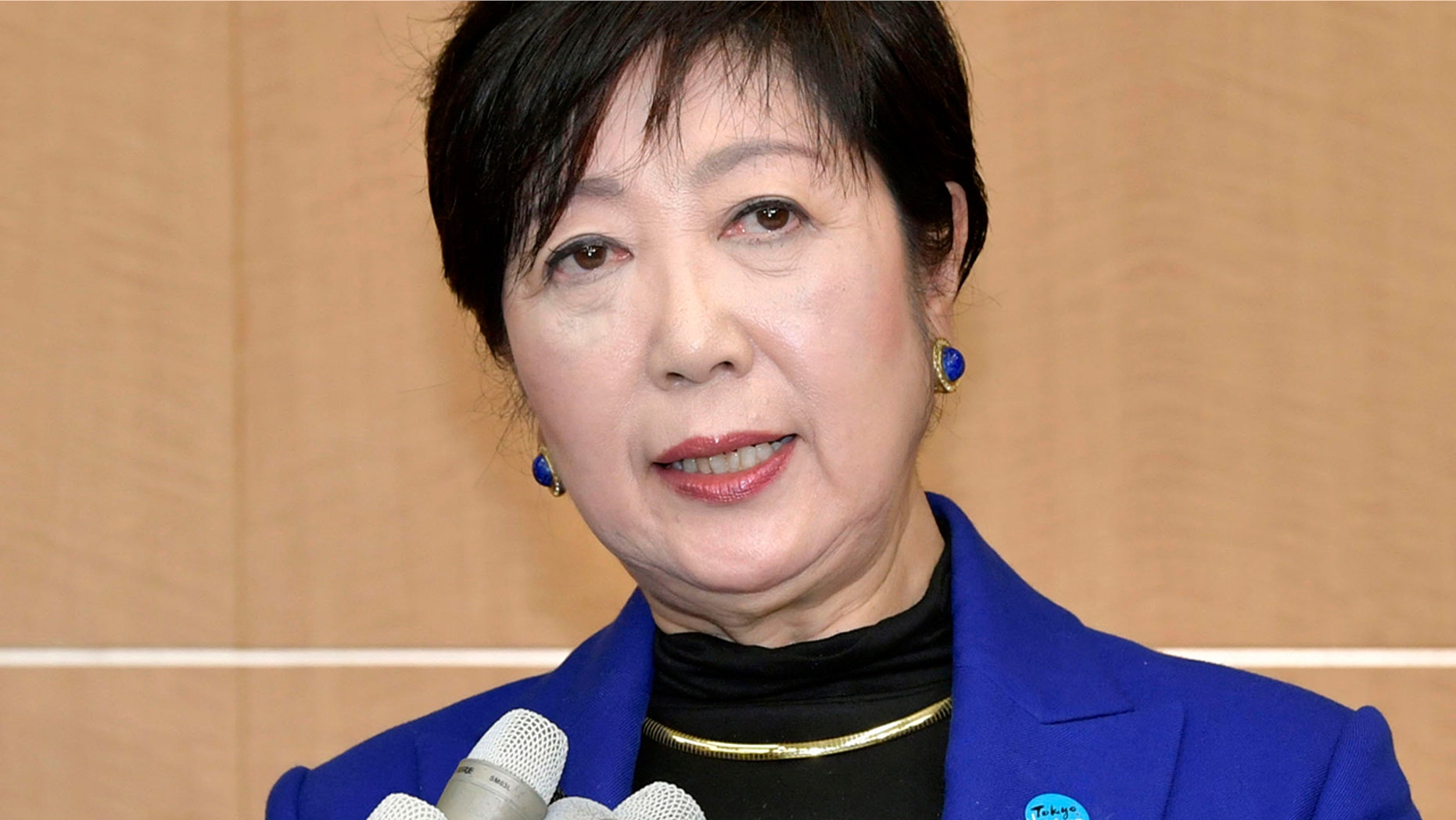 FILE - In this Wednesday, Oct. 30, 2019, file photo, Tokyo Gov. Yuriko Koike speaks to reporters after a meeting with International Olympic Committee officials in Tokyo. The International Olympic Committee abruptly announced two weeks ago it was moving next year’s Olympic marathon from Tokyo to the northern city of Sapporo. The change has infuriated Koike and created a public fight between the powerful, Switzerland-based IOC, and Tokyo which is spending about $25 billion to organize the Olympics - 80% public money. (Kyodo News via AP, File)