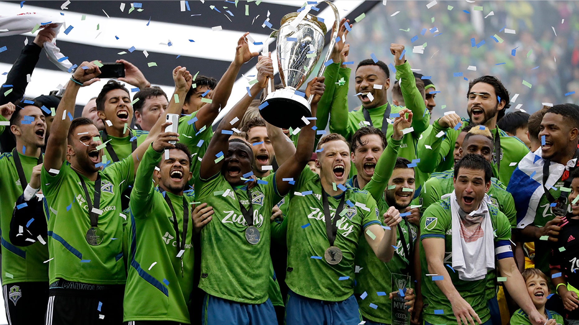 Seattle Sounders celebrate Sunday, Nov. 10, 2019, after the team beat the Toronto FC in the MLS Cup championship soccer match in Seattle. The Sounders won 3-1. (AP Photo/Elaine Thompson)