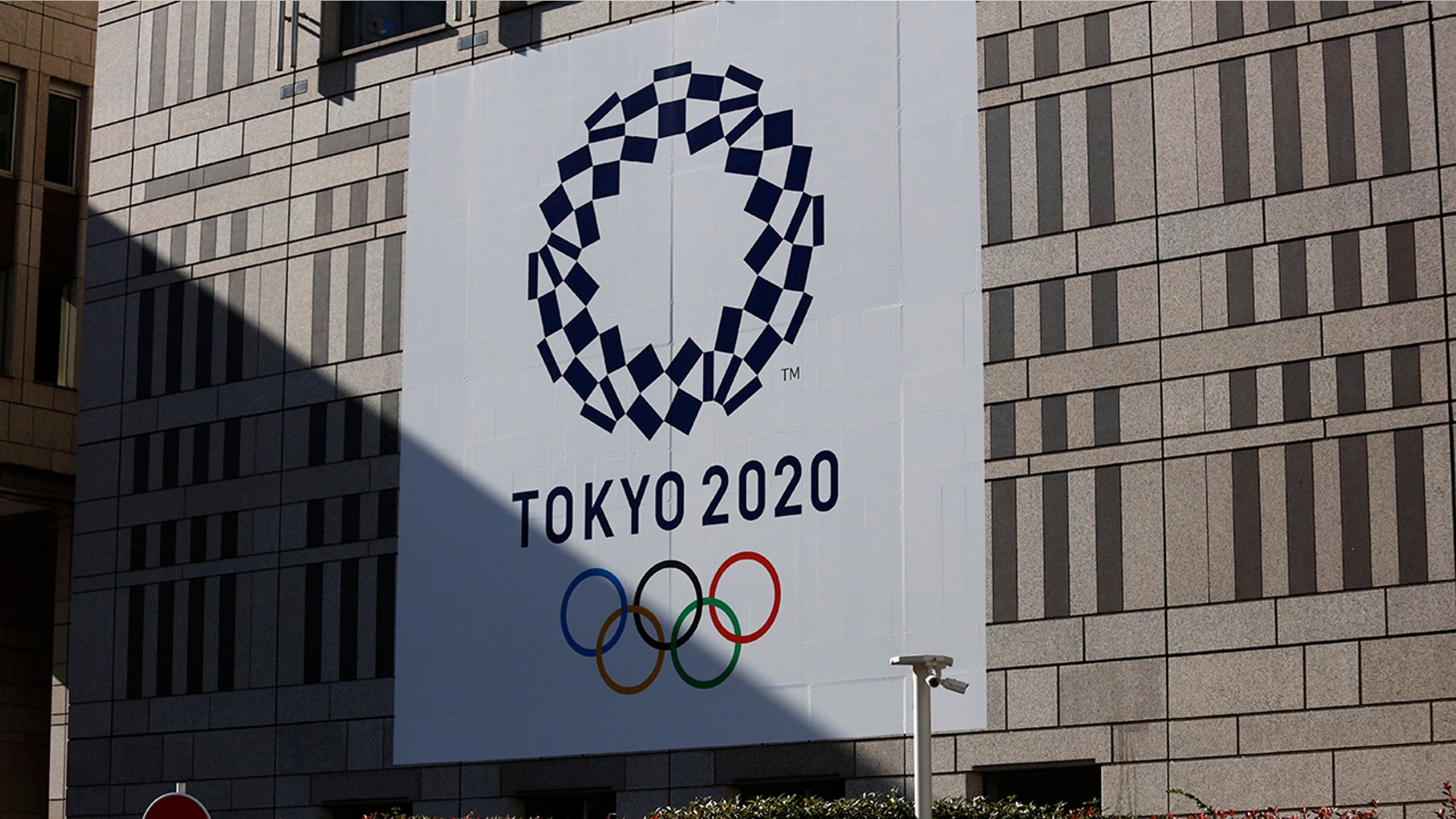 A man walks past a large Tokyo 2020 banner hanging on the facade of the Tokyo Metropolitan Government building Thursday, Nov. 21, 2019, in Tokyo. The French language has been almost invisible during the drawn-out preparations for next year’s Tokyo Olympics.(AP Photo/Jae C. Hong)