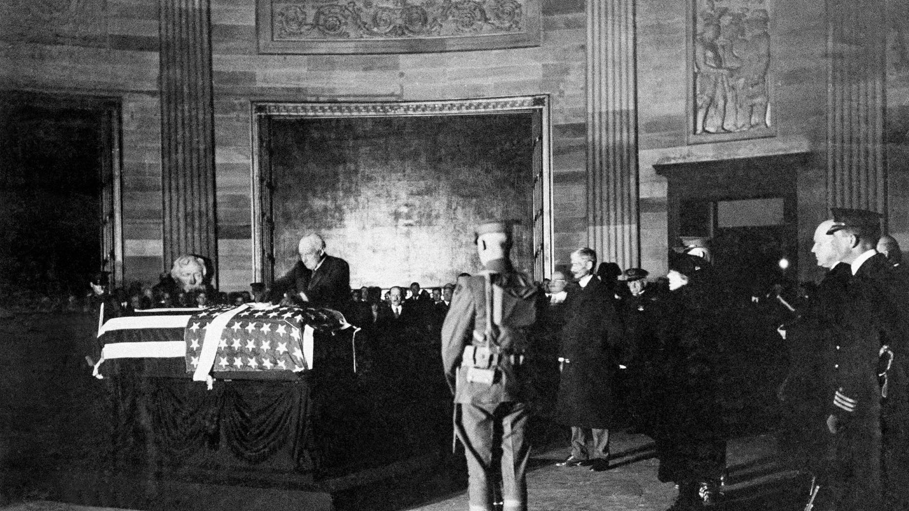 President Warren G. Harding places a wreath on the casket of an unknown soldier from World War I in the rotunda of the U.S. Capitol, Nov. 11, 1921 in Washington. (AP Photo)