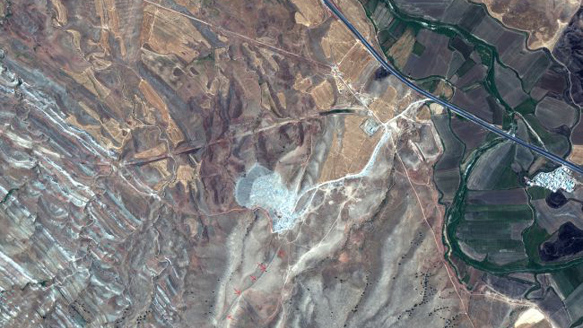 This satellite image was taken on July 31, 2019 by the WorldView-2 satellite. The red arrows show a surviving section of the Gawri Wall. (Credit: 2019 Maxar Technologies)