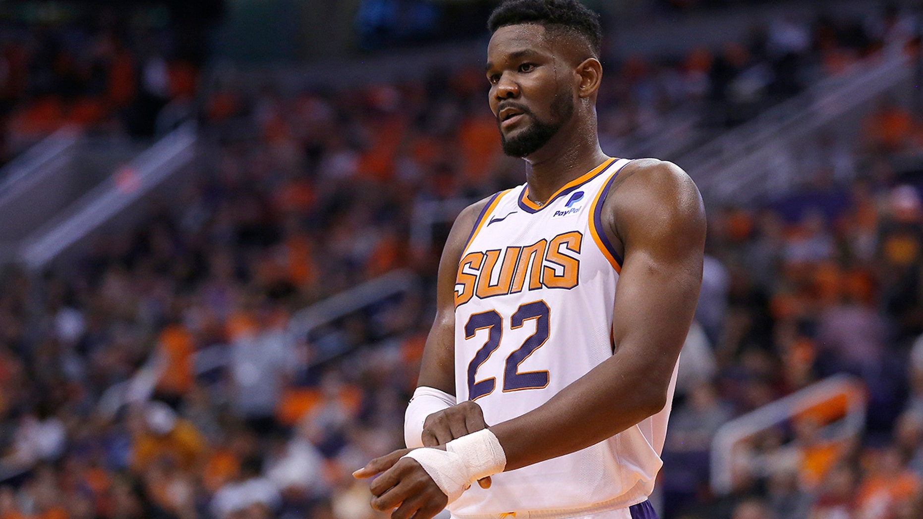 FILE - In this Oct. 23, 2019 file photo Phoenix Suns center Deandre Ayton (22) in the first half during an NBA basketball game against the Sacramento Kings in Phoenix. Ayton returns to the Suns on Tuesday, Dec. 17, 2019 against the Los Angeles Clippers after missing the season's first 25 games for violating the NBA's drug policy. (AP Photo/Rick Scuteri)