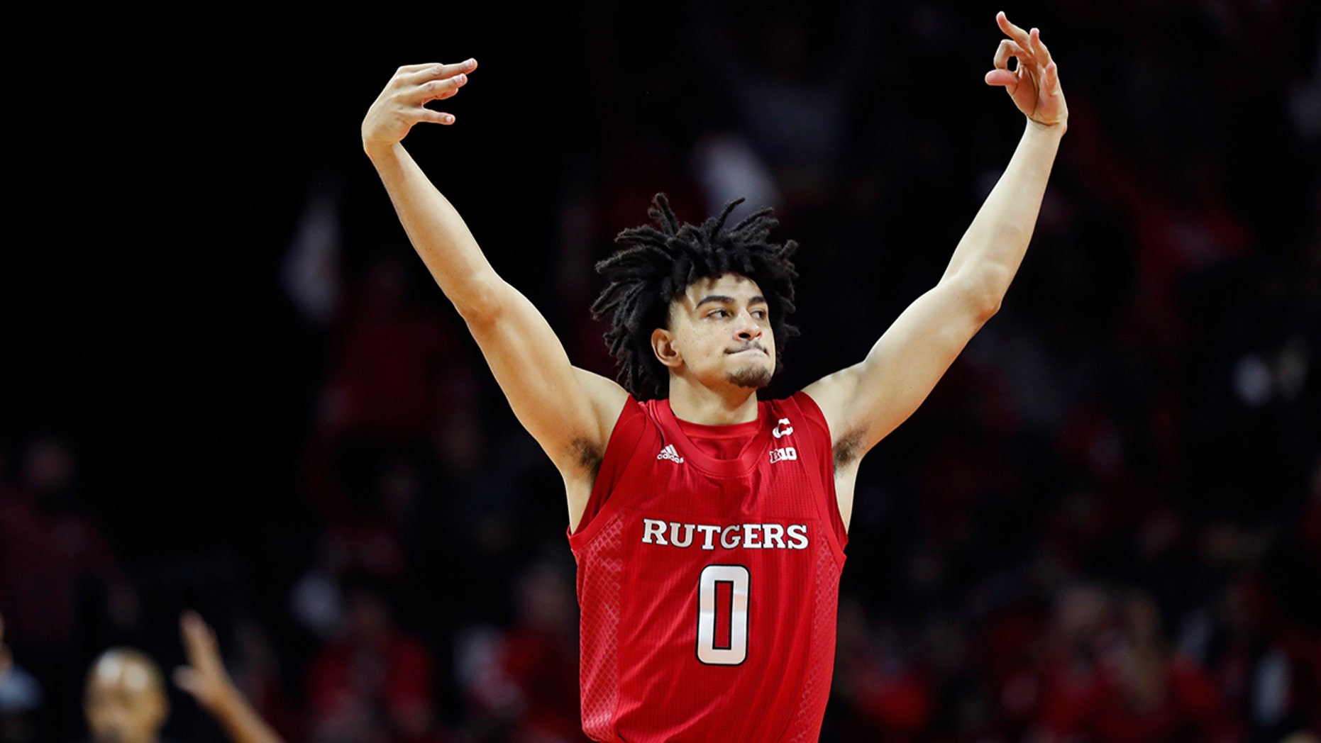Rutgers guard Geo Baker (0) celebrates after hitting a three-point shot during the first half of an NCAA college basketball game against Seton Hall, Saturday, Dec. 14, 2019, in Piscataway, N.J. (AP Photo/Kathy Willens)