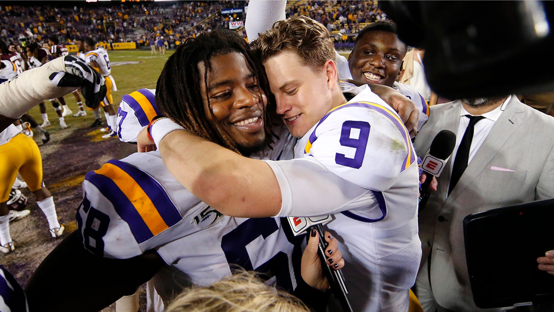 LSU quarterback Joe Burrow (9) hugs guard Damien Lewis after the team's NCAA college football game against Texas A&M in Baton Rouge, La., Saturday, Nov. 30, 2019. LSU won 50-7. (AP Photo/Gerald Herbert)