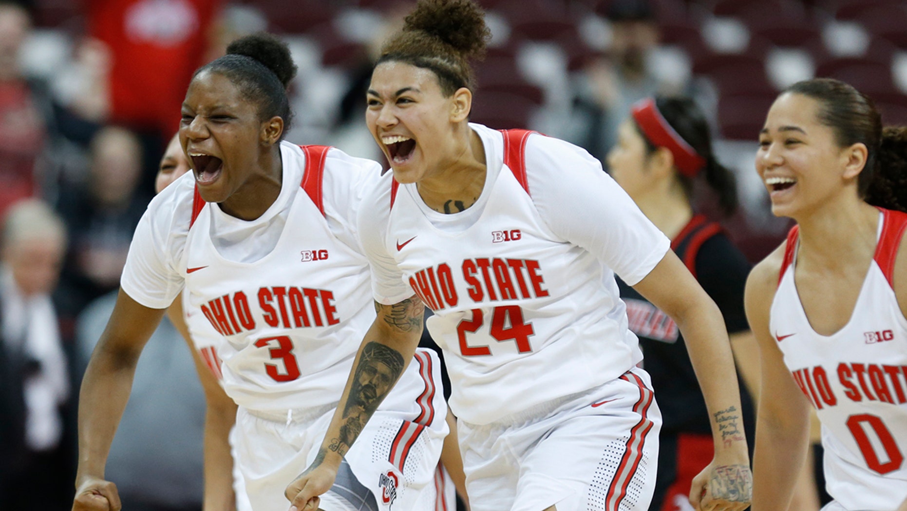 Ohio State guard Janai Crooms, left, guard Kierstan Bell and guard Madison Greene celebrate the team's win over Louisville in an NCAA college basketball game in Columbus, Ohio, Thursday, Dec. 5, 2019. (AP Photo/Paul Vernon)