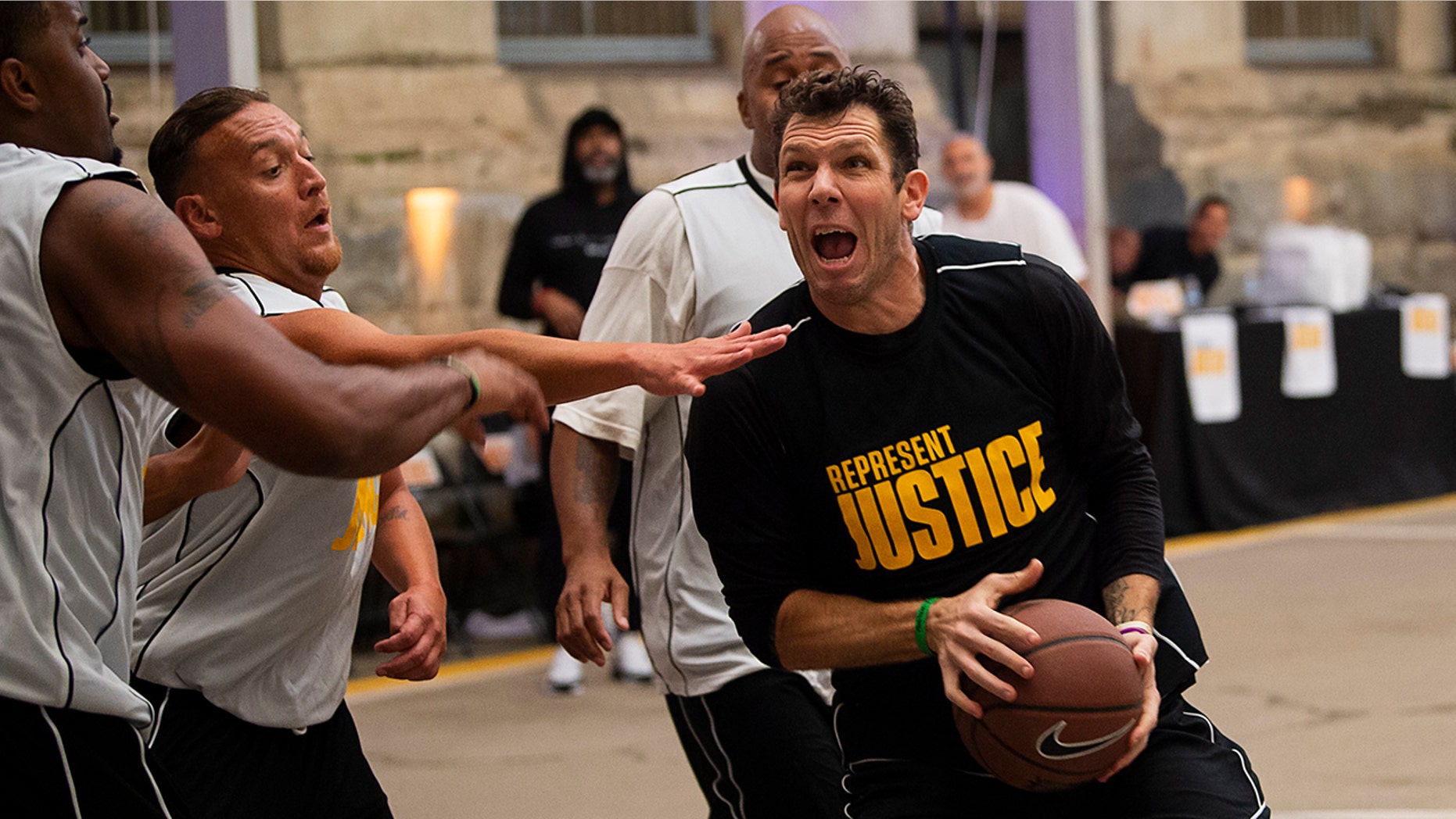 In this Thursday, Dec. 12, 2019 photo, Sacramento Kings coach Luke Walton plays basketball with a team of inmates as the Kings and the Represent Justice Campaign host a game at Folsom State Prison in Folsom, Calif. (Paul Kitagaki Jr./The Sacramento Bee via AP, Pool0