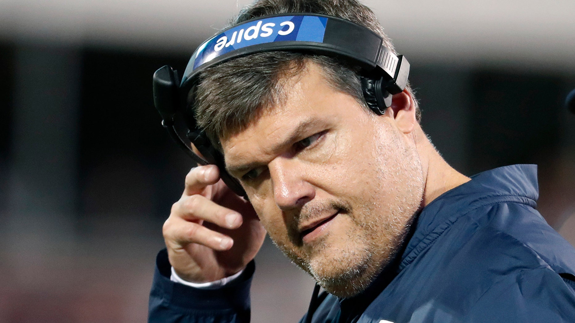 In this Nov. 28, 2019 photo, Mississippi head coach Matt Luke removes his headset during an NCAA college football game against Mississippi State, in Starkville, Miss. Mississippi has fired Luke, three days after his third non-winning season ended with an excruciating rivalry game loss. Athletic director Keith Carter said Sunday, Dec. 1, 2019 the decision to change coaches was made after evaluating the trajectory of the program and not seeing enough “momentum on the field.” (AP Photo/Rogelio V. Solis)