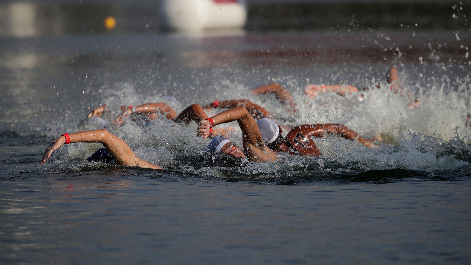 FILE - In this Aug. 11, 2019, file photo, athletes compete in a marathon swimming test event at Odaiba Marine Park, a venue for marathon swimming and triathlon at the Tokyo 2020 Olympics, in Tokyo. The IOC moved next year’s Tokyo Olympic marathons and race walks out of the Japanese capital to avoid the stifling heat and humidity. Some swimmers and an 11,000-member coaching body want similar treatment: find an alternative to the distance-swimming venue in Tokyo Bay known as the “Odaiba Marine Park.”(AP Photo/Jae C. Hong, File)