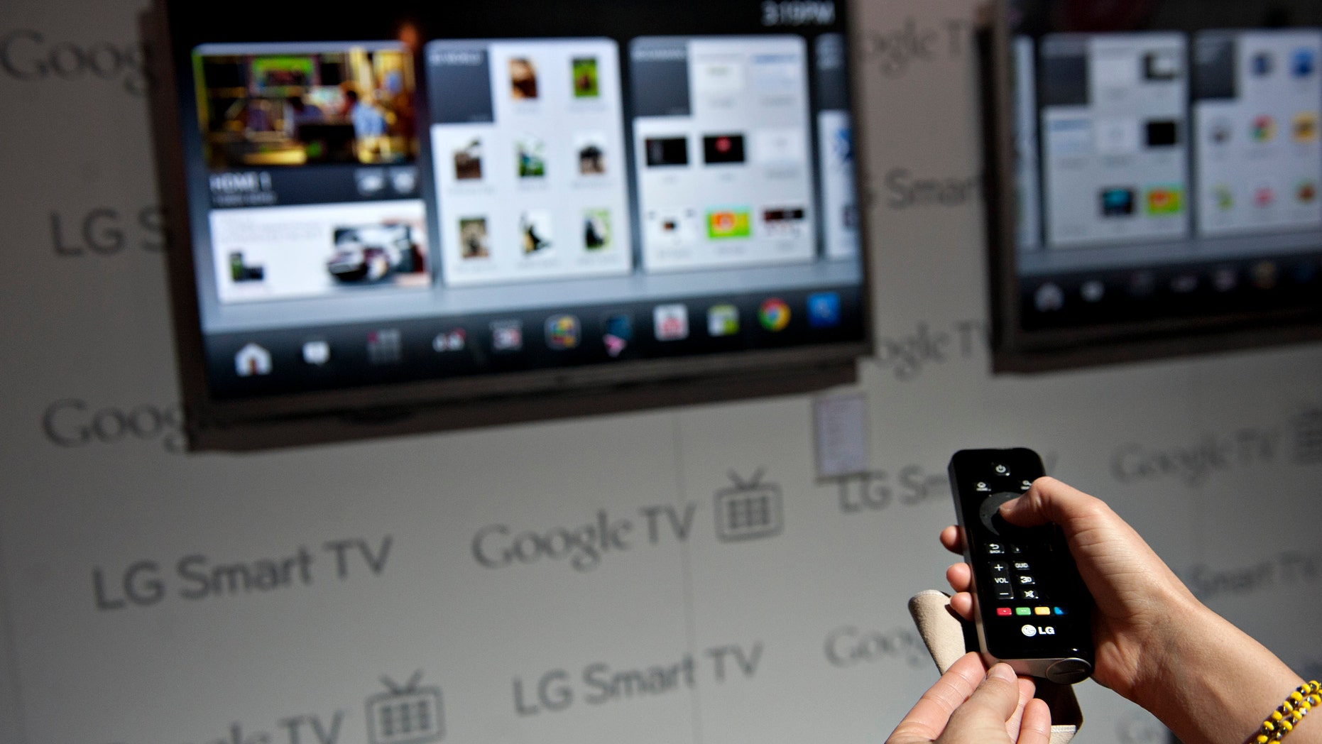 A product demonstrator uses a remote control to navigate a menu on a LG Smart TV with Google TV at the 2012 International Consumer Electronics Show (CES) in Las Vegas, Nevada, U.S., on Wednesday, Jan. 11, 2012 - file photo.