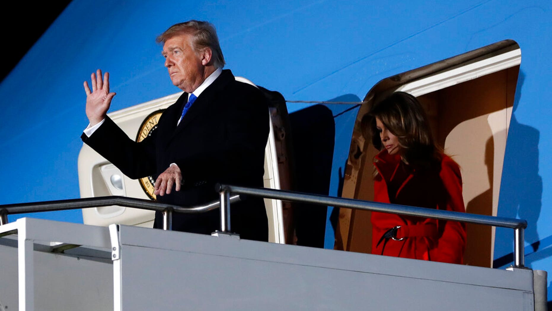 President Donald Trump waves as he and first lady Melania Trump arrive at Stansted Airport in England, Monday, Dec. 2, 2019. US President Donald Trump will join other NATO heads of state at Buckingham Palace in London on Tuesday to mark the NATO Alliance's 70th birthday. (AP Photo/Evan Vucci)