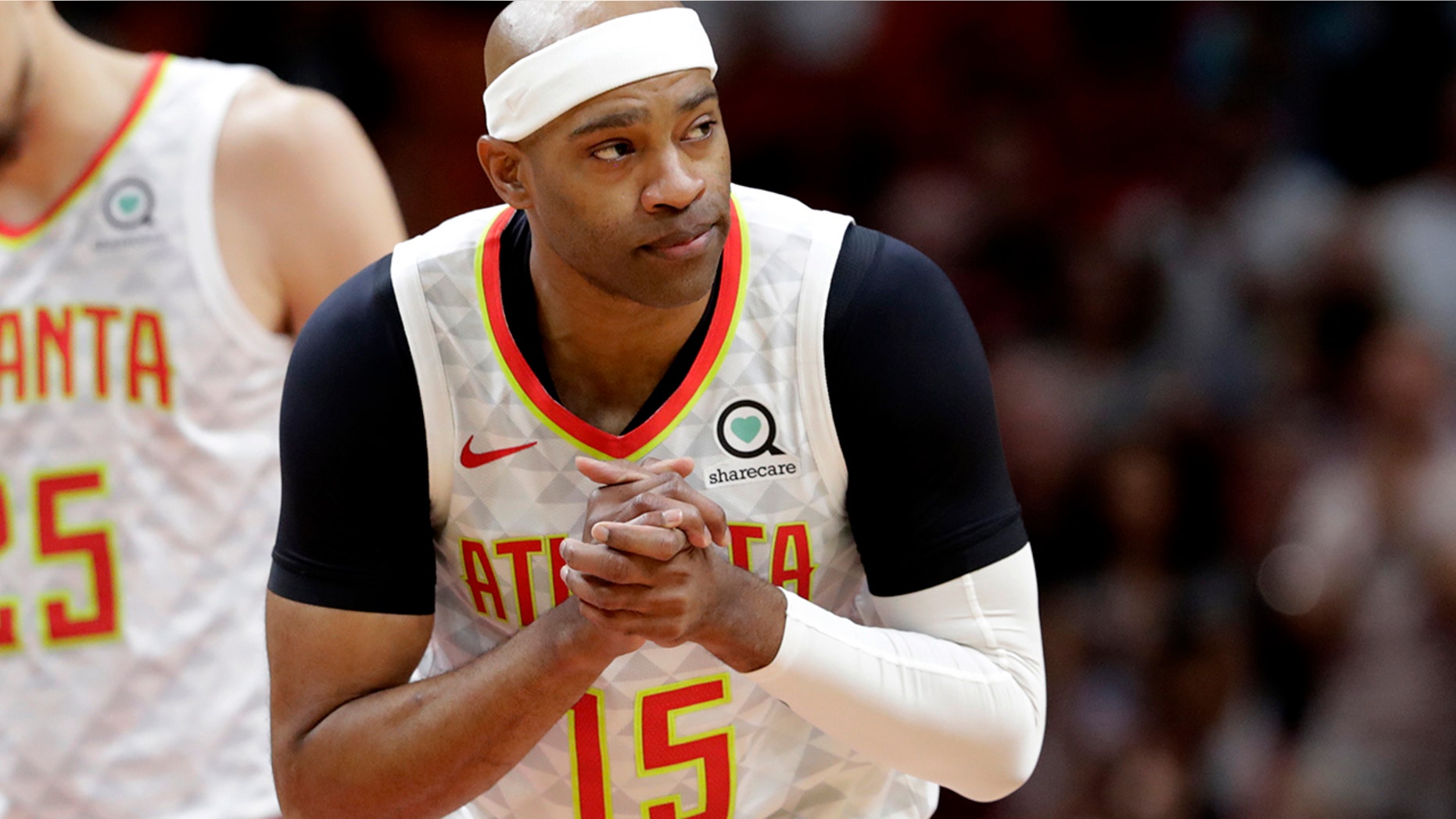Atlanta Hawks guard Vince Carter (15) acknowledges the crowd after bring introduced during the first half of an NBA basketball game against the Miami Heat, Tuesday, Dec. 10, 2019, in Miami. (AP Photo/Lynne Sladky)
