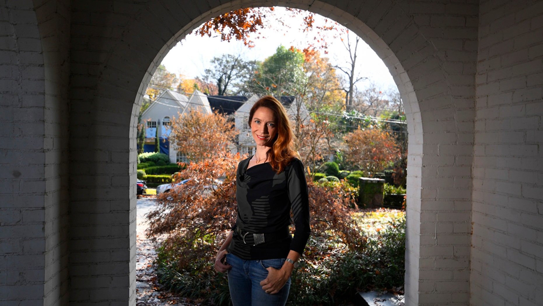 In this Nov. 27, 2019, photo, Georgia Tech professor Kim Cobb poses for a photo at her home in Atlanta. Some climate scientists and activists, including Cobb, are limiting their flying, their consumption of meat and their overall carbon footprints to avoid adding to the global warming they study. (AP Photo/John Amis)