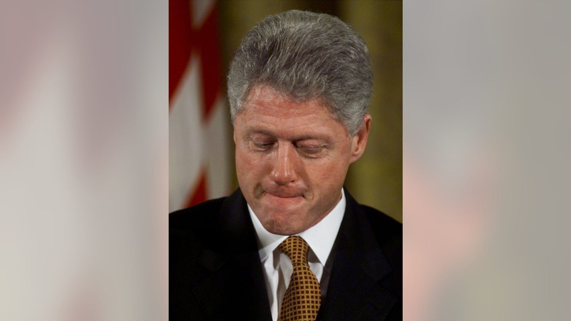 President Clinton waits to make remarks on his education agenda during an event in the East Room of the White House in Washington, Thursday, Jan. 7, 1999. As the president went about his official duties, the Senate opened the first presidential impeachment trial in 130 years, swearing to "do impartial justice" in judging whether President Clinton should be removed from office. (AP Photo/J. Scott Applewhite)