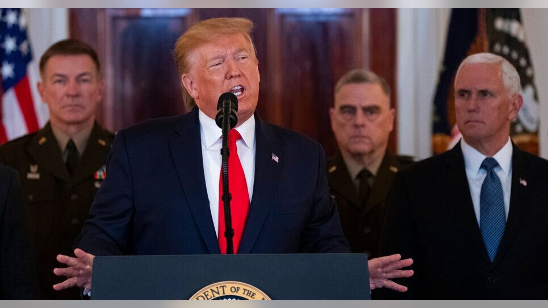 President Donald Trump addresses the nation from the White House on the ballistic missile strike that Iran launched against Iraqi air bases housing U.S. troops as Chairman of the Joint Chiefs of Staff Gen. Mark Milley, Vice President Mike Pence, and others look on. (AP Photo/ Evan Vucci)