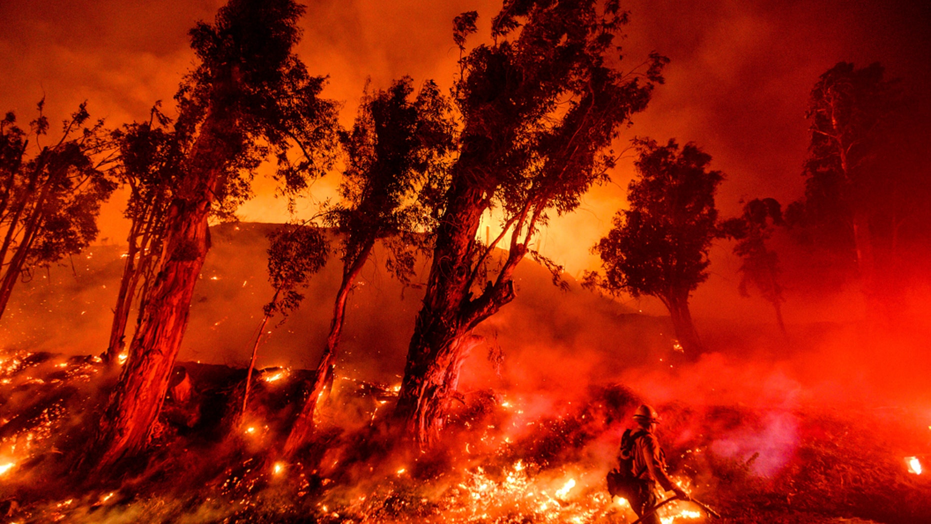 FILE - In this Nov. 1, 2019, file photo, flames from a backfire consume a hillside as firefighters battle the Maria Fire in Santa Paula, Calif. The decade that just ended was by far the hottest ever measured on Earth, capped off by the second-warmest year on record, NASA and the National Oceanic and Atmospheric Administration reported Wednesday, Jan. 15, 2020. (AP Photo/Noah Berger, File)