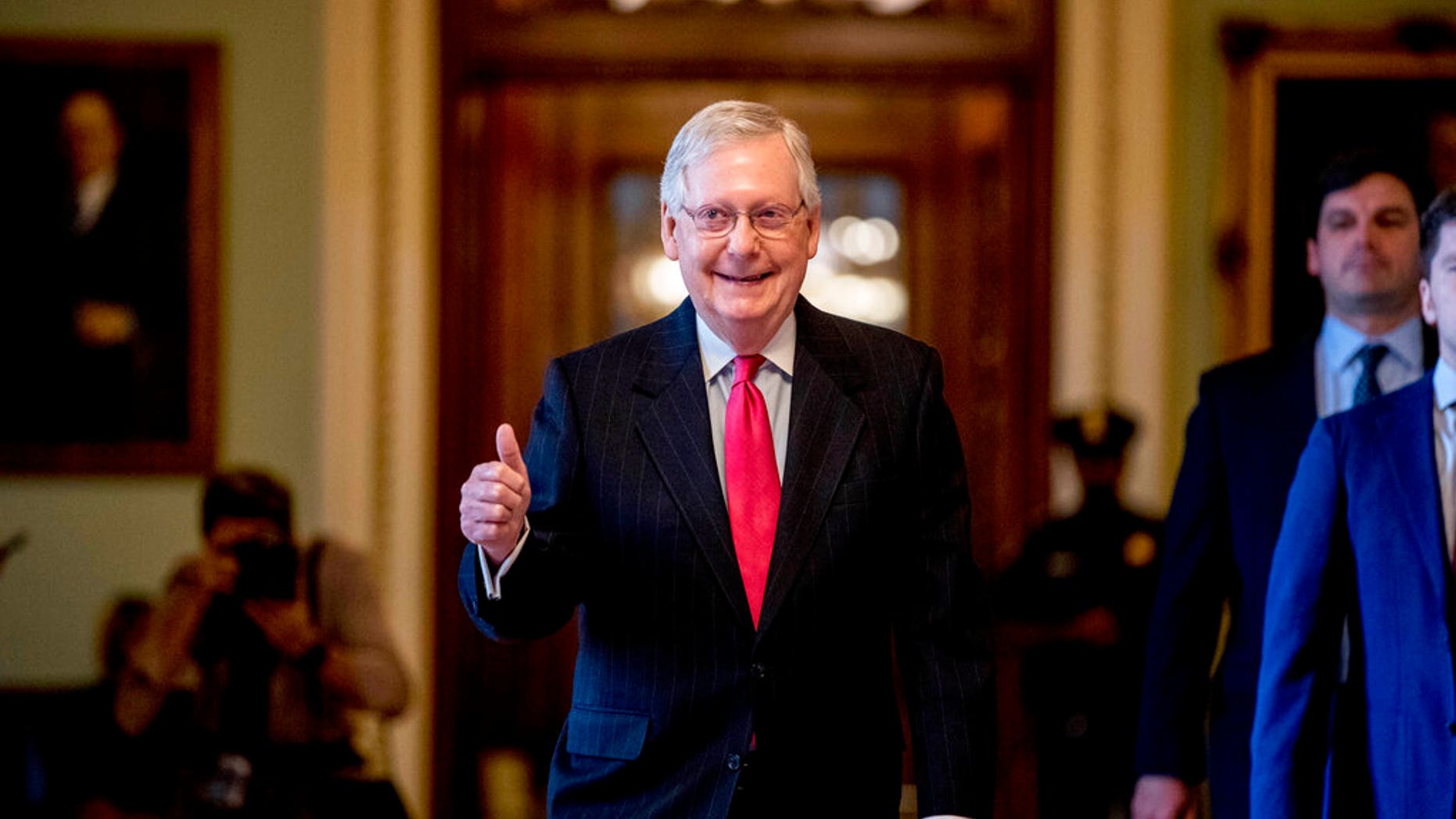 Senate Majority Leader Mitch McConnell of Ky. gives a thumbs up as he leaves the Senate chamber on Capitol Hill in Washington. (AP Photo/Andrew Harnik)