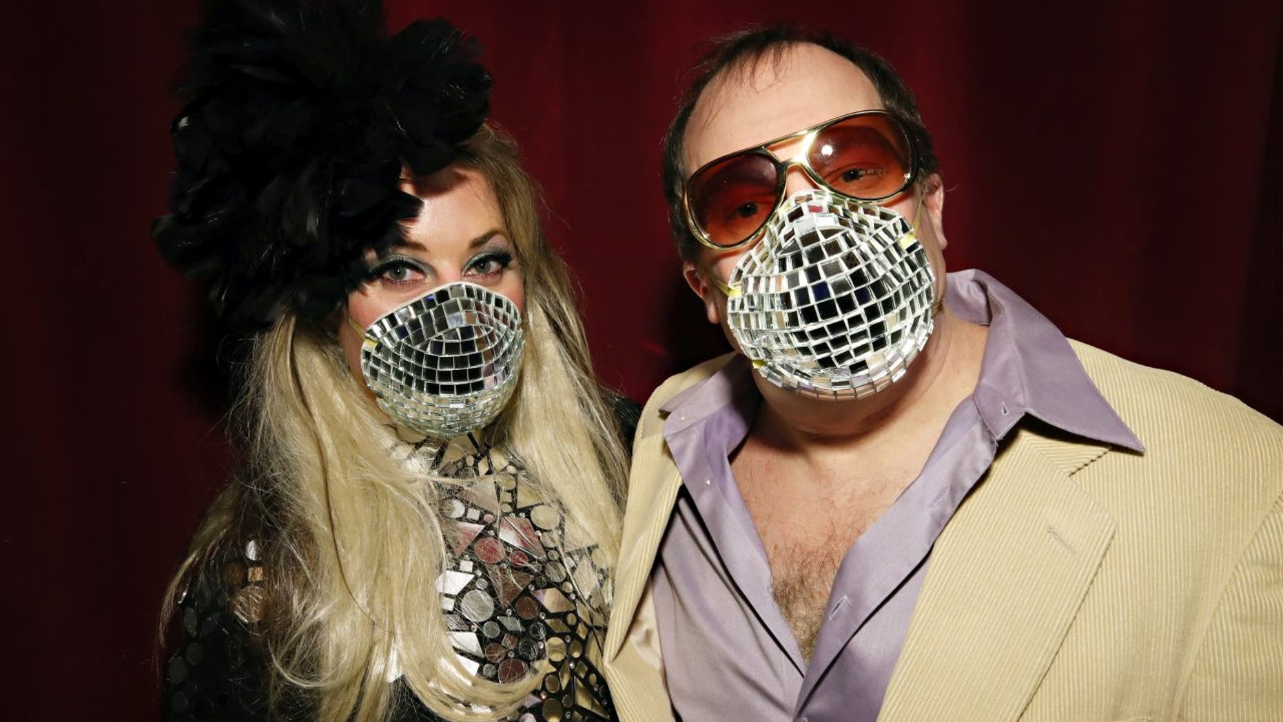 Allison Eden and Gary Goldenstein wear decorated masks inspired by the Coronavirus disease (COVID-19) threats during "Studio 54: Night Magic" Opening Night at the Brooklyn Museum on March 11, 2020.
