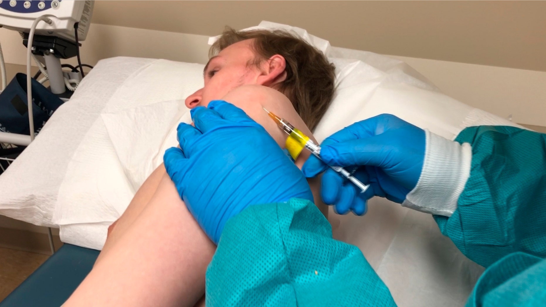 In this Wednesday, April 8, 2020 photo provided by the Center for Pharmaceutical Research, a participant in a COVID-19 coronavirus vaccine trial receives an injection in Kansas City, Mo.