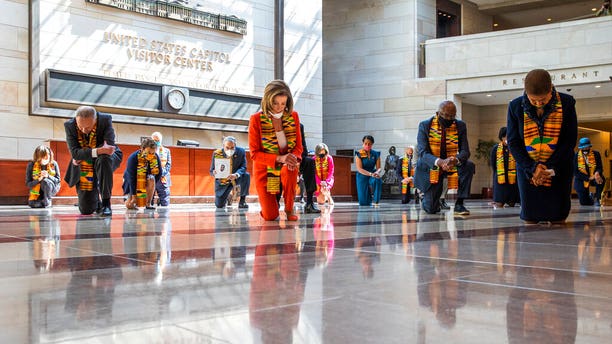 House Speaker Nancy Pelosi of Calif., center, and other members of Congress, kneel and observe a moment of silence at the Capitol's Emancipation Hall, Monday, June 8, 2020, on Capitol Hill in Washington, reading the names of George Floyd and others killed during police interactions. Democrats proposed a sweeping overhaul of police oversight and procedures Monday, an ambitious legislative response to the mass protests denouncing the deaths of black Americans at the hands of law enforcement. (AP Photo/Manuel Balce Ceneta)