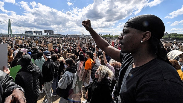 Thousands of people demonstrate in Cologne, Germany, Saturday June 6, 2020, to protest against racism and the recent killing of George Floyd by police officers in Minneapolis, USA. His death has led to Black Lives Matter protests in many countries and across the US. A US police officer has been charged with the death of George Floyd. (AP Photo/Martin Meissner)