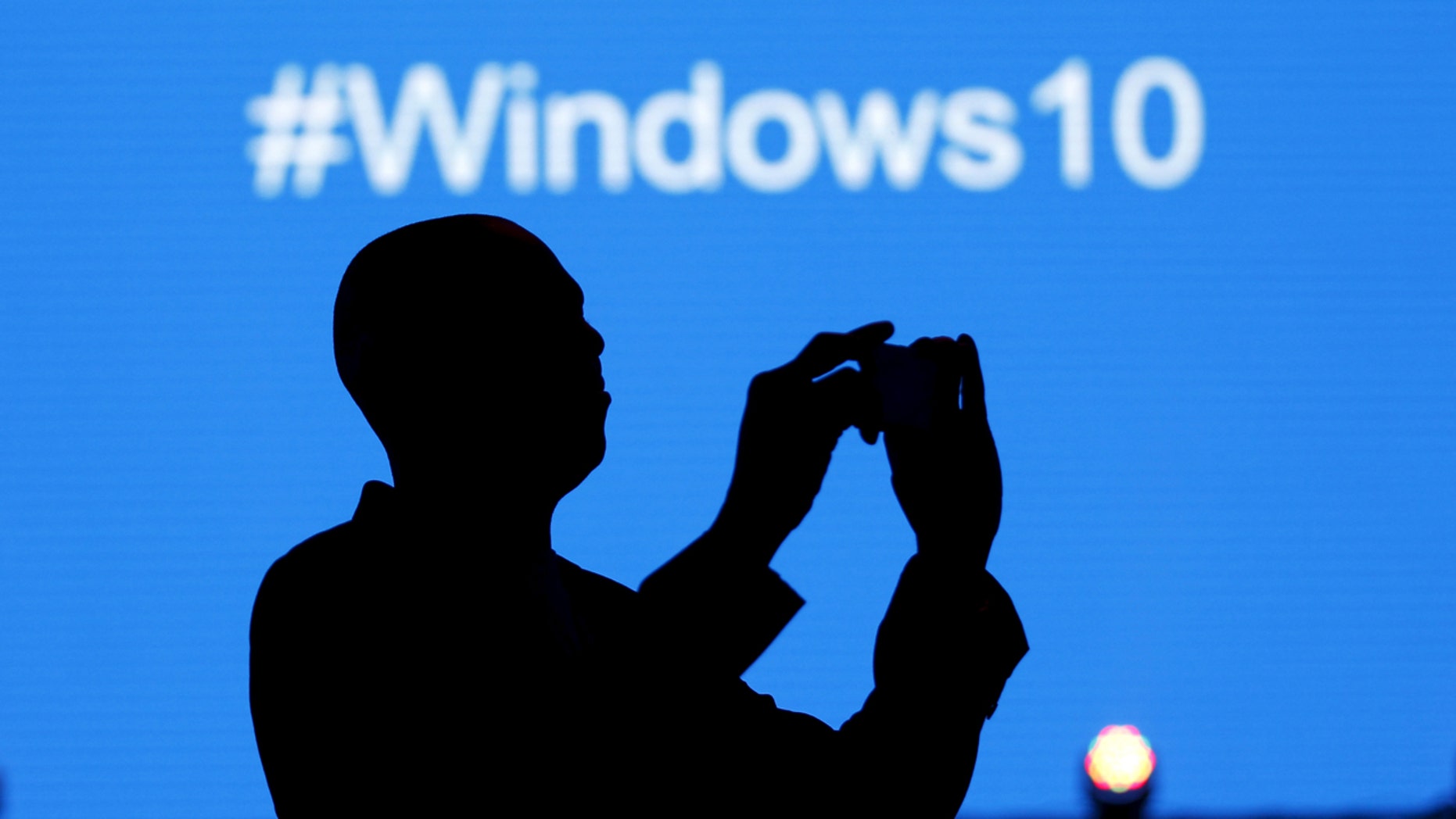 A Microsoft delegate takes a photo during the launch of the Windows 10 operating system in Nairobi, the capital of Kenya, July 29, 2015 - file photo.