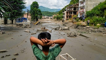 KID LOOKING AT DAMAGE - Fox News
