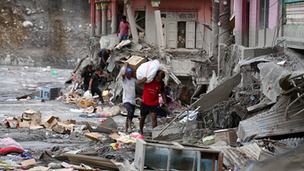 man in red walking through debris - Fox News