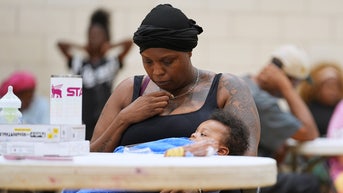 WOMAN HOLDING BABY AT SHELTER - Fox News