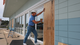 man in blue shirt boarding business - Fox News