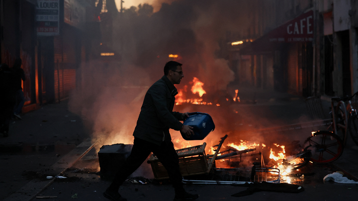 MAN WITH BUCKET IN FRONT OF FIRE - Fox News