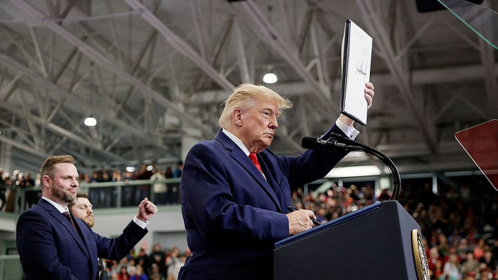 holding up sign - Fox News