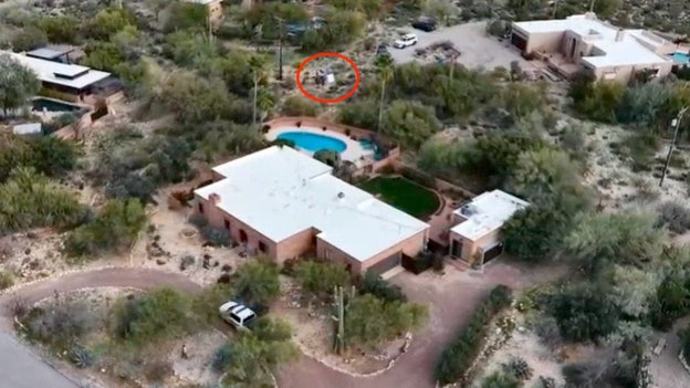 Law enforcement searching behind Nancy Guthrie's home