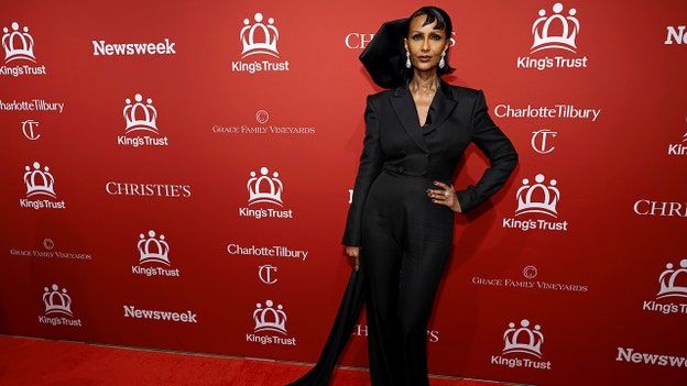 Supermodel Iman spotted on King's Trust gala red carpet in black draped ensemble