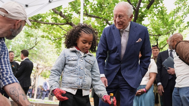 King Charles plants lavender with NYC kids at Harlem farm