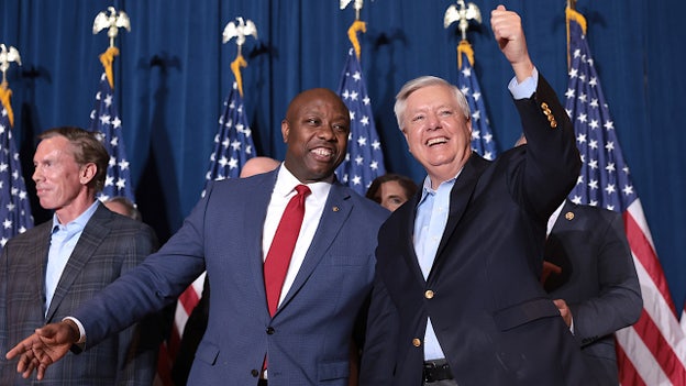 Sen. Tim Scott congratulates fellow South Carolina Sen. Lindsey Graham on fending off primary