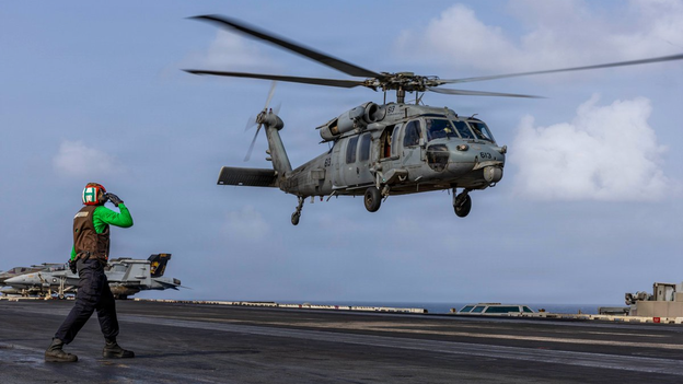 The helicopter takes off from the USS Abraham Lincoln, an aircraft carrier.