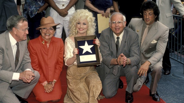 Dolly Parton on the Walk of Fame with Sylvester Stallone (Getty Images)